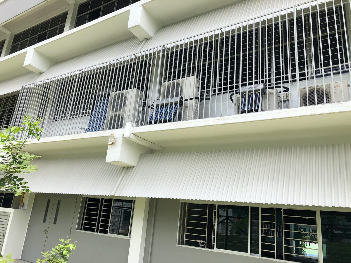 Solar thermal cooling units installed along an institutional building walkway