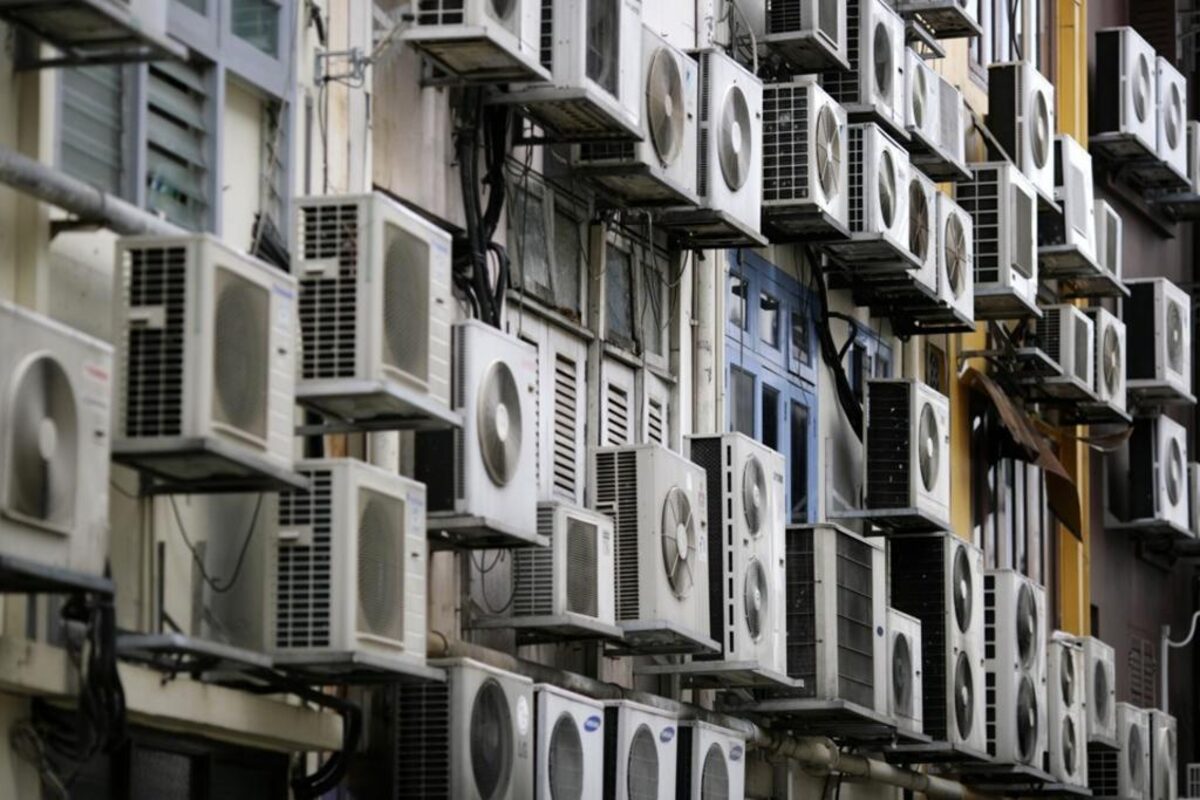 Dense array of conventional condensing units on a building facade